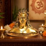 Compact gold-coloured Adiyogi statue on a decorative base