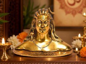 Compact gold-coloured Adiyogi statue on a decorative base