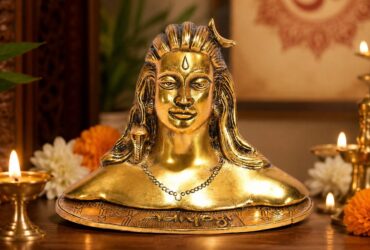 Compact gold-coloured Adiyogi statue on a decorative base