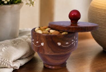 Decorative wooden bowl with matching lid and carved details