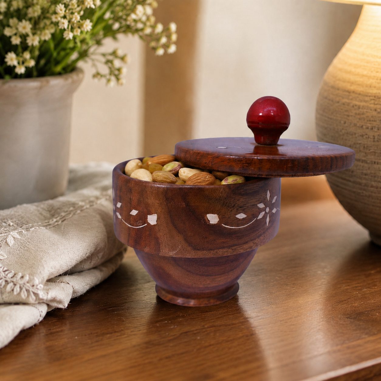Decorative wooden bowl with matching lid and carved details